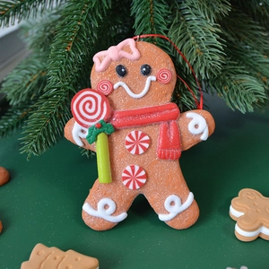 Gingerbread man Christmas tree ornament with red scarf and white icing details