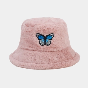 Detailed view of pink plush bucket hat featuring exquisite blue butterfly embroidery