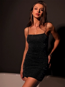 Close-up of black sequin bodycon dress showing glittering fabric and slim strap detail