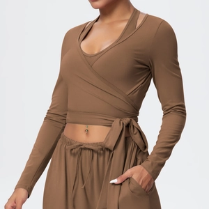 Detail of dark brown yoga wrap top with side tie and soft brushed stretch fabric