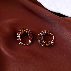 Vintage style gold-plated round hoop earrings with amber crystals on brown silk