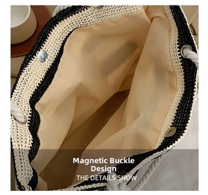 Detail showing the magnetic clasp closure and lining of the striped woven tote bag