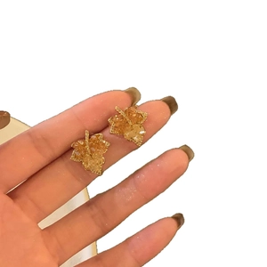 Exquisite 14k gold plated maple leaf stud earrings with sparkling cubic zirconia crystals