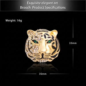Luxury tiger head brooch with crystal rhinestones and green eyes on black background