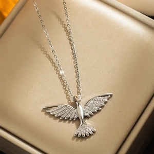 Silver phoenix pendant necklace with cubic zirconia on beige velvet jewelry box stand