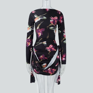 Detail shot of the ruched fabric texture and purple floral print on the slim mini dress