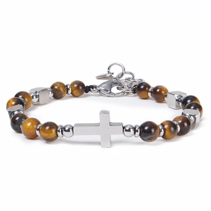 Close-up of brown tiger eye beads and silver cross pendant on beaded bracelet