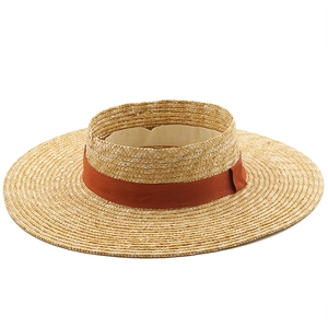 Fashionable straw sun visor with wide brim and rust red ribbon for summer outdoor beach use