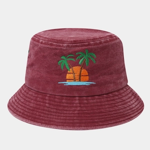 Detailed embroidery of coconut palm trees and sunset on burgundy washed cotton bucket hat