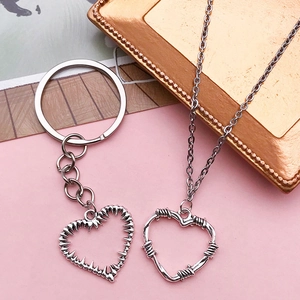 Retro silver heart pendants with thorn and wire designs on keychain and necklace