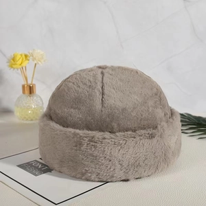 Detailed view of thick grey faux fur texture and rolled brim on a warm docker hat