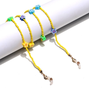Yellow beaded lanyard for glasses or masks with colorful clay flower charms and gold clips