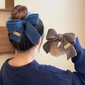 Knitted bow hair scrunchies in blue and brown with plush texture and cute bear leather tag