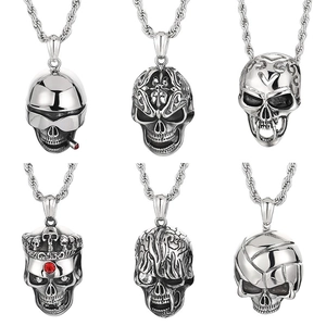 Six vintage stainless steel skull pendants with rhinestone details in a set