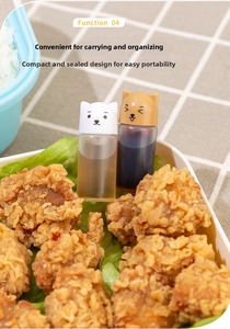 Close-up of mini dog-shaped sauce bottles used for dressing in a lunch box setup