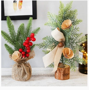Detail of 25cm pine needle Christmas tree with red berries and rustic wooden base