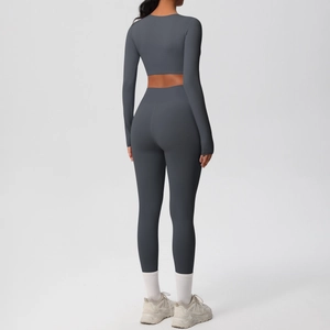 Rear view of charcoal grey yoga set featuring long sleeve cropped top and high waist leggings