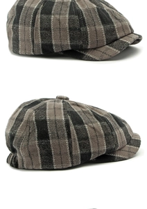 Detail view of the thick wool fabric and dark gray plaid texture on this newsboy cap