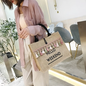 Linen jute tote bag with HELLO WEEKEND print and colorful fringe tassel trim