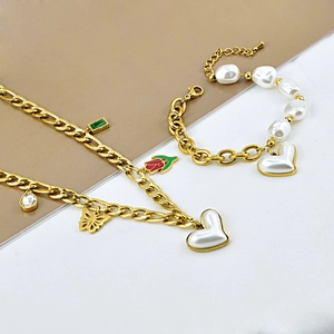 Gold chain jewelry set with white heart pearl, butterfly, and tulip charms
