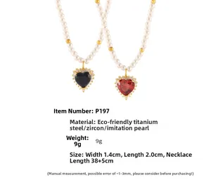 Detail of heart pendants with zircon pave and imitation pearls on gold-plated titanium steel