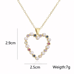Detailed view of gold heart necklace with pearls and colorful zircons showing 2.9cm size