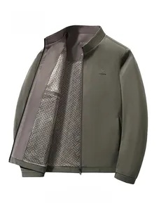 Detail of khaki jacket inner lining with geometric texture and logo on the chest