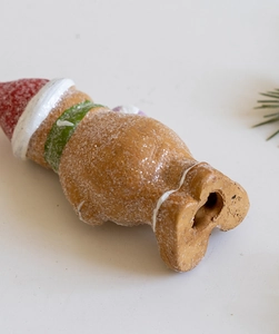 Close-up of glitter-coated Christmas resin gnome ornament with festive textures