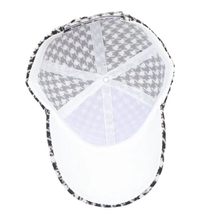 Detailed interior of a houndstooth baseball cap with white lining and reinforced seams