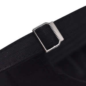 Macro detail of black cotton baseball cap with adjustable strap and silver metal buckle