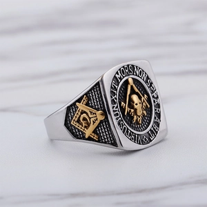 Men's Freemason skull signet ring in two-tone stainless steel on marble background