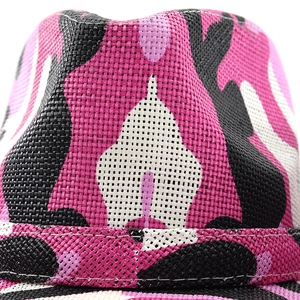 Macro shot of pink camouflage pattern on woven straw texture of this western cowboy hat