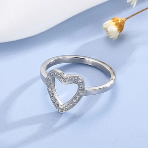 Detailed view of hollow heart ring with pave-set white cubic zirconia in silver finish