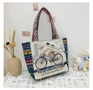 Close-up of ethnic tote bag featuring Penang street art and colorful bohemian woven straps