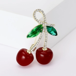 Sparkling cherry fruit brooch with red enamel and green crystals on golden base