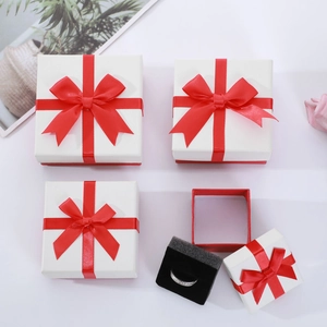 White square jewelry gift box with red bow and black sponge insert for rings