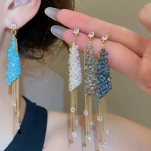 Detail of elegant tassel drop earrings with square crystals in four color variants