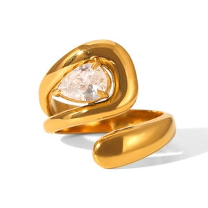 Macro shot of gold fluid ring featuring a pear-cut zircon in a minimalist organic design