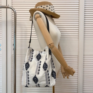 Ethnic cotton linen tote bag with delicate floral embroidery and long shoulder strap