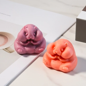 Macro detail of cute marmot shaped scented candles in purple and pink tones