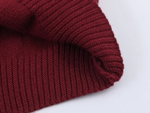 Close-up of wine red ribbed knit fabric texture showing high-quality wool fibers