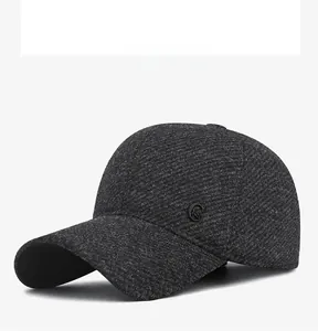 Detail view of dark grey textured tweed baseball cap showing the side logo and fabric