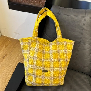 Winter yellow plaid plush tote bag with large capacity and soft tweed texture on a chair