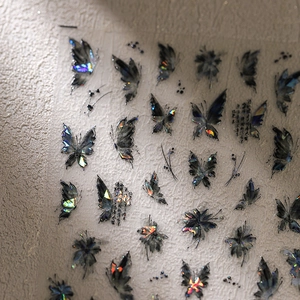Bronzing butterfly nail stickers with laser holographic effect on black base elements