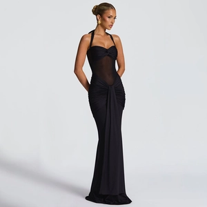 Detail of elegant black halter evening dress featuring ruched fabric and sheer mesh waist