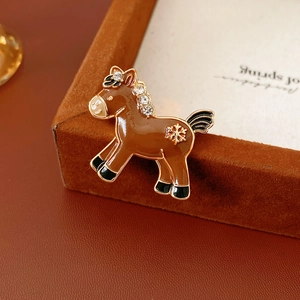 Detail of horse brooch with brown enamel, white rhinestones and golden snowflake pattern