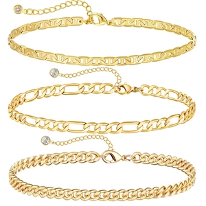 Three gold anklets set with figaro and cuban link styles featuring small crystal charms