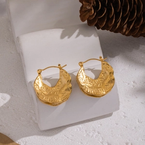 Textured gold leaf-style C-shape earrings with hammered finish on geometric base
