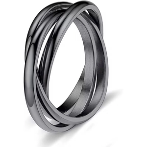 Detailed macro shot of interlocking triple-band titanium rings with a matte black finish