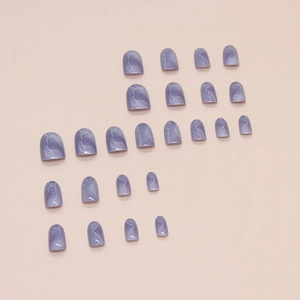Short round lilac purple press-on nails with white marble pattern on pink background